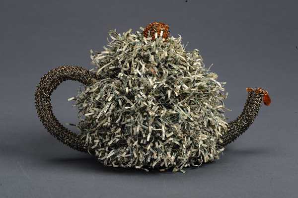 John Dulla uses old coins and dollar bills to create jewelry and art pieces like this money teapot